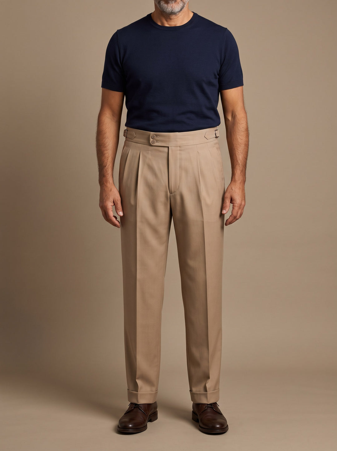 Roman trousers in Beige, worn by a model on a warm taupe studio background - Gentlemens Manor