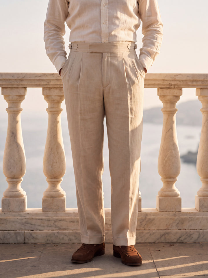Roman trousers in Beige, worn by a model at a marble balustrade above the coast, Gentlemens Manor lifestyle