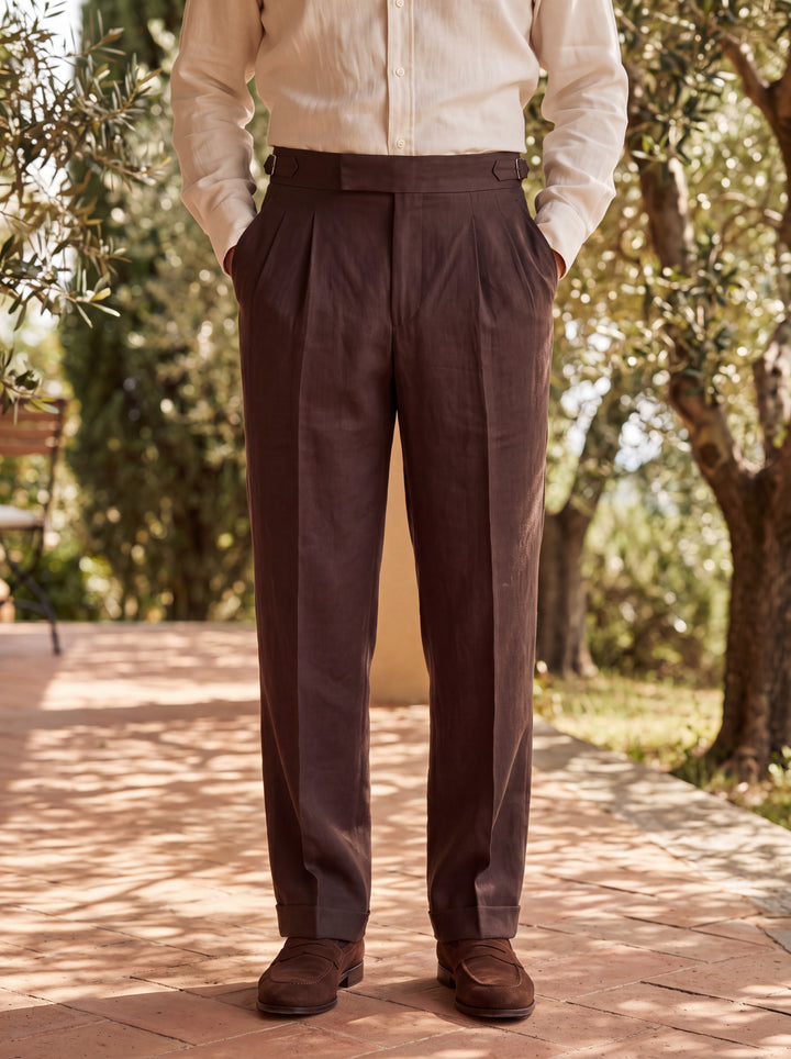 Roman trousers in Brown, worn by a model on a shaded garden veranda, Gentlemens Manor lifestyle
