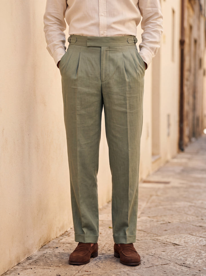 Roman trousers in Green, worn by a model in a sunlit Mediterranean lane, Gentlemens Manor lifestyle