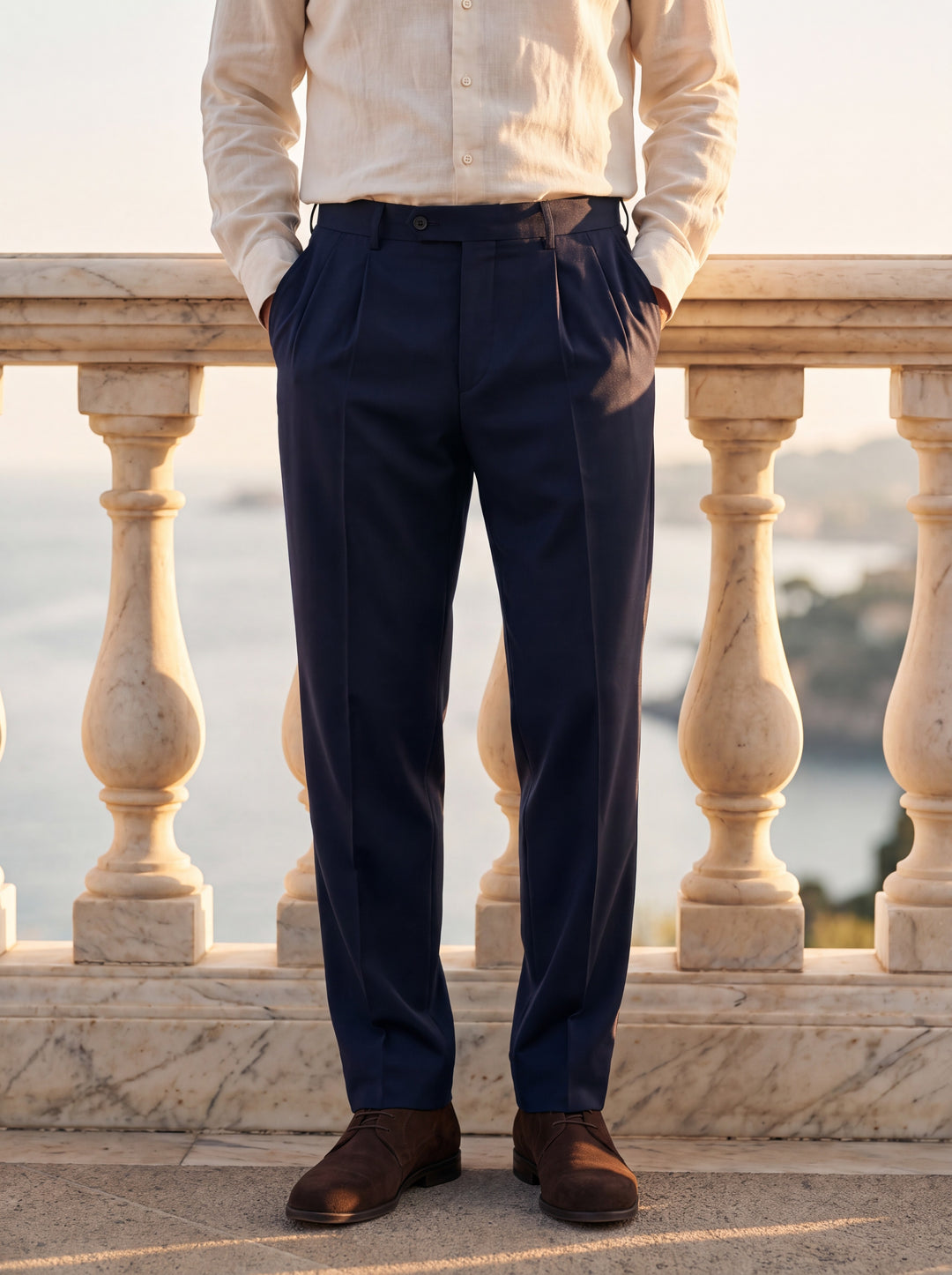 Roman Men trousers in Navy, worn by a model on a Mediterranean terrace - Gentlemens Manor lifestyle
