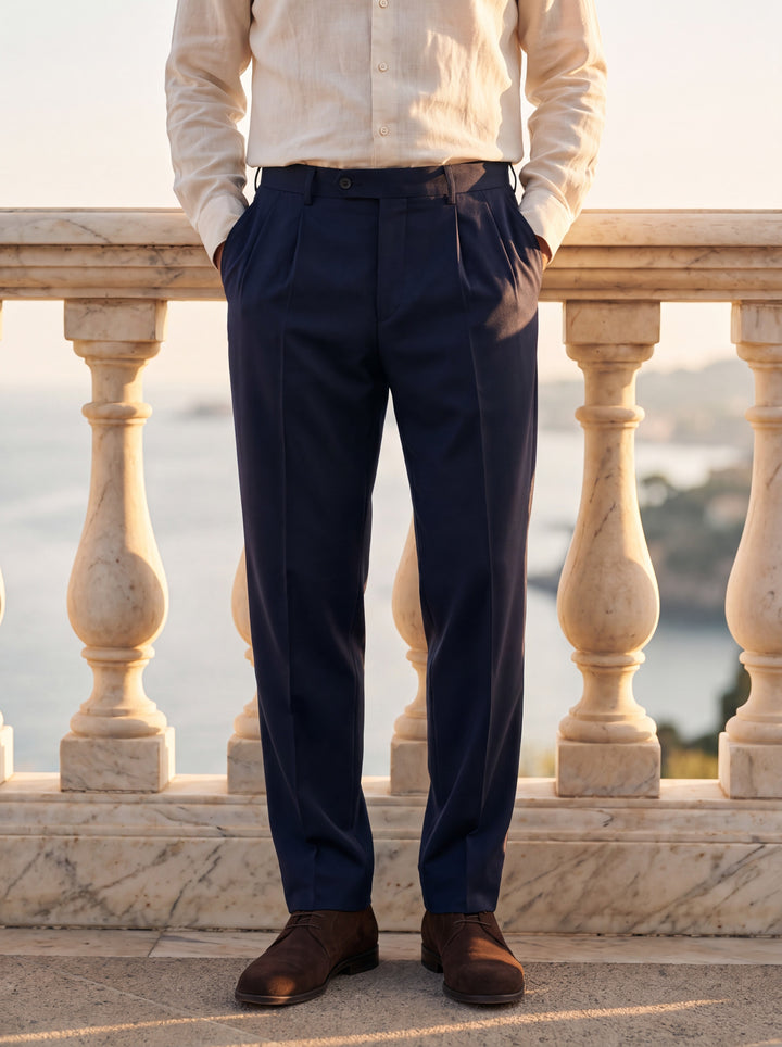 Roman Men trousers in Navy, worn by a model on a Mediterranean terrace - Gentlemens Manor lifestyle