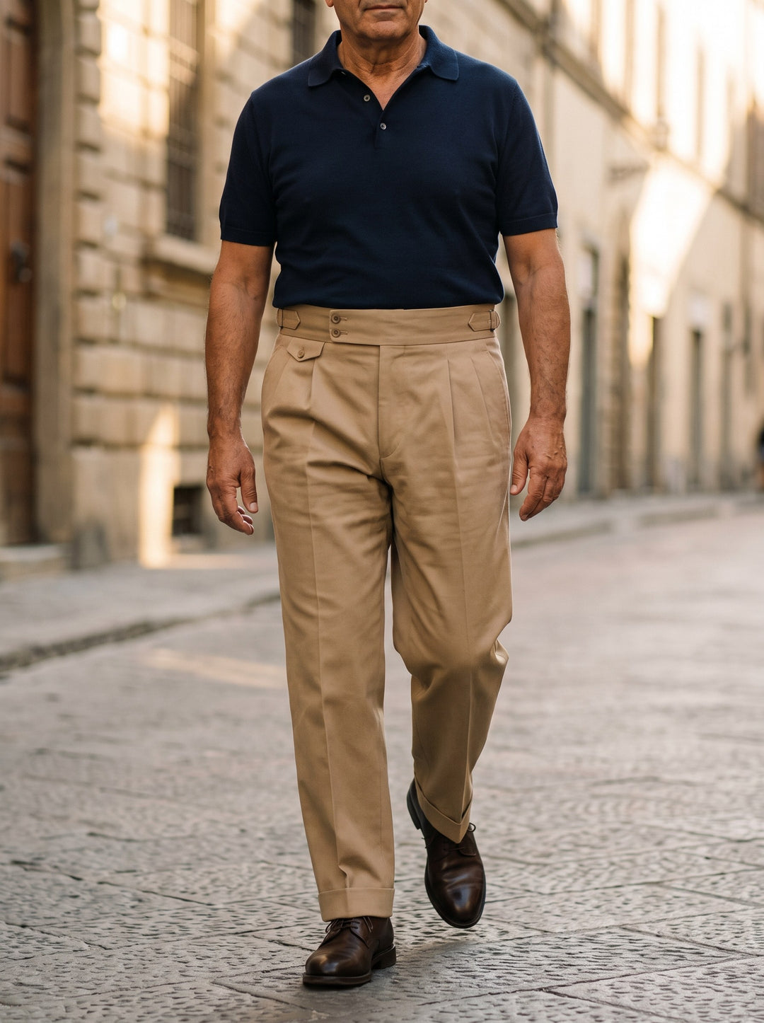 Roman trousers in Sand, worn by a model on a sunlit city street - Gentlemens Manor lifestyle