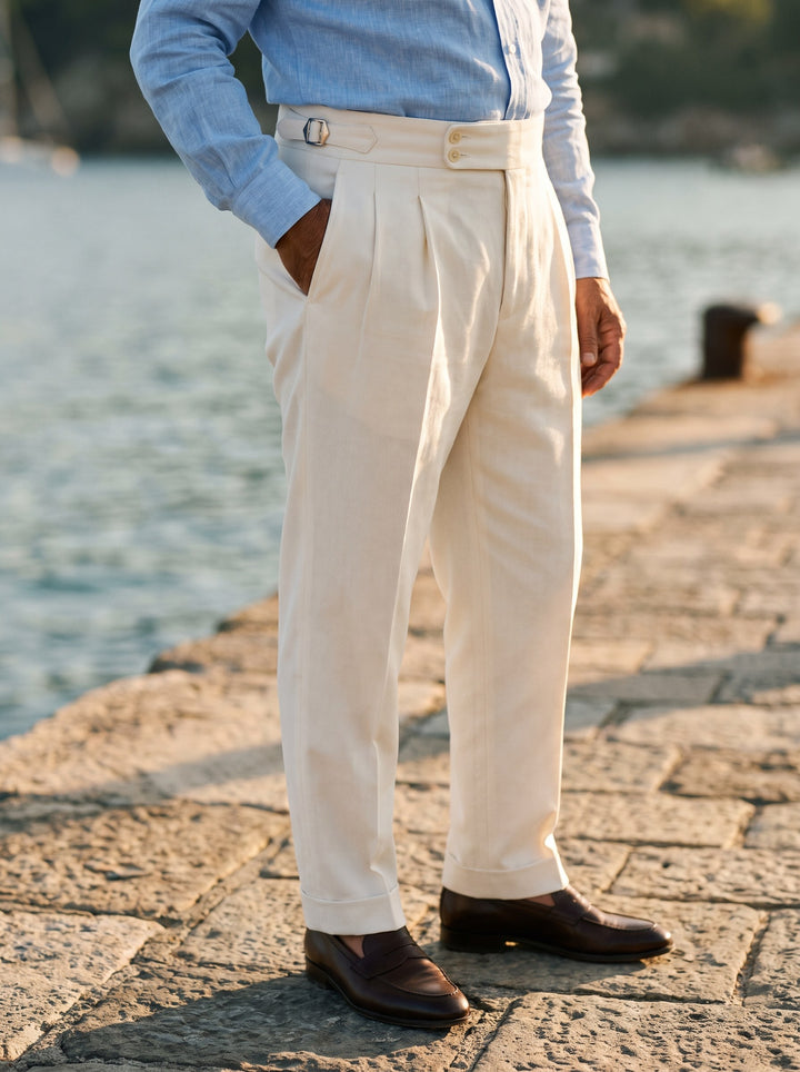 Roman trousers in White, worn by a model on a coastal stone quay - Gentlemens Manor lifestyle
