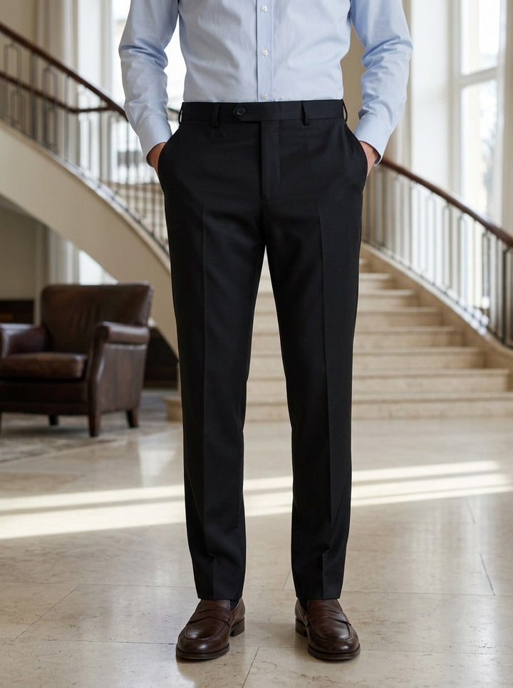 Saunders flat front dress trousers in Black, lifestyle in a hotel lobby, Gentlemens Manor