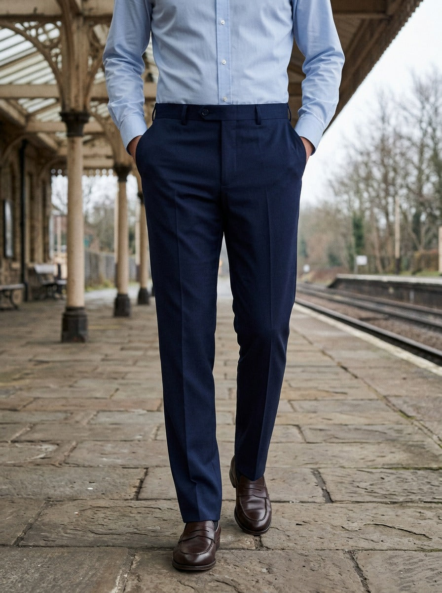 Saunders flat front dress trousers in Navy, lifestyle on a railway platform, Gentlemens Manor