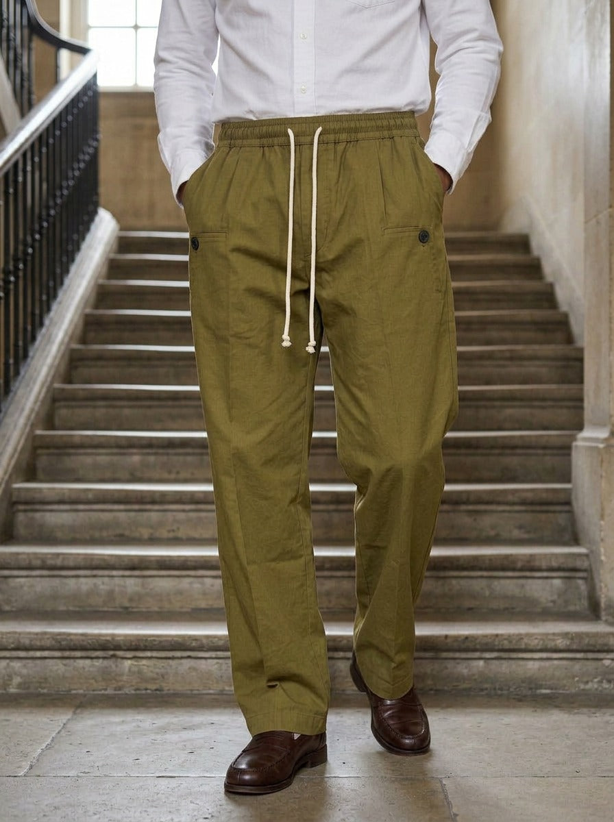 Sedley pleated drawstring crease trousers in Olive, lifestyle on a civic stone staircase, Gentlemens Manor