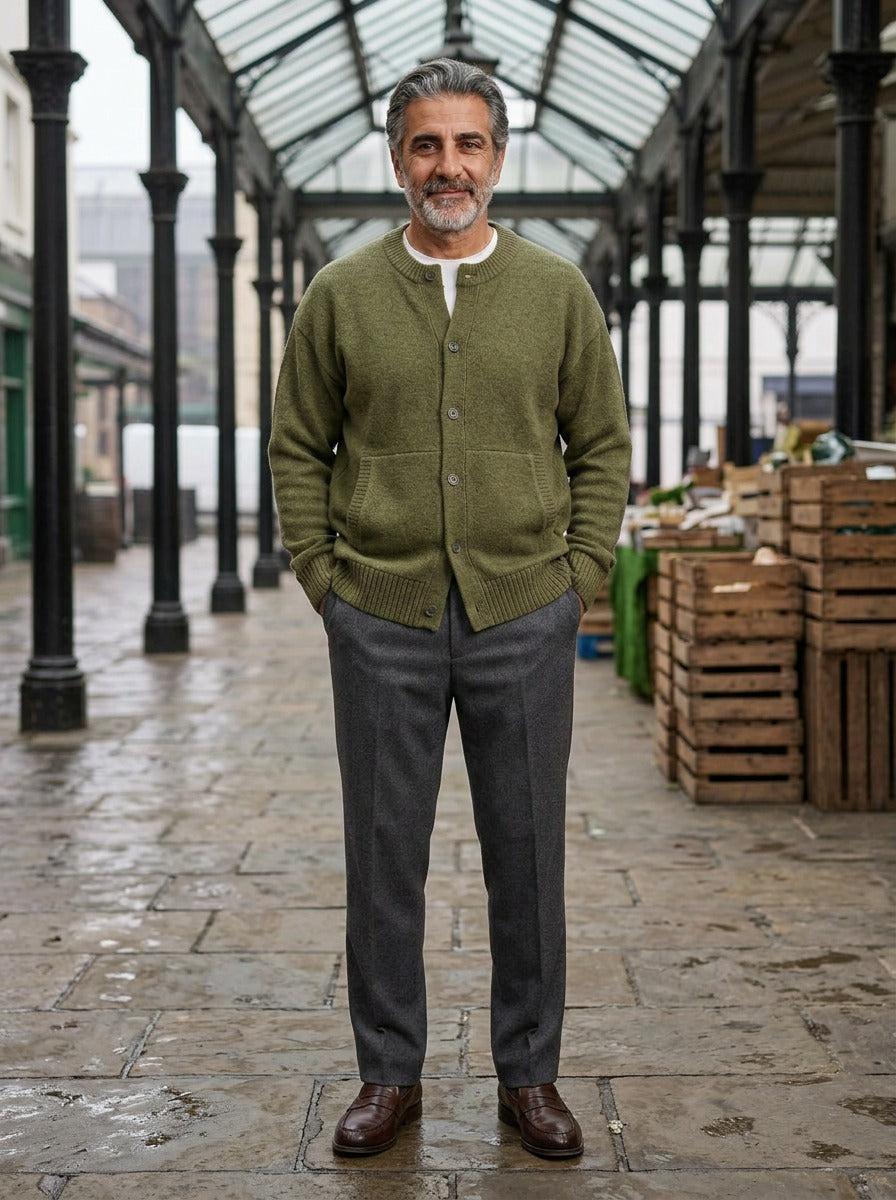 Selby round neck cardigan in Olive, lifestyle in a covered market hall, Gentlemens Manor