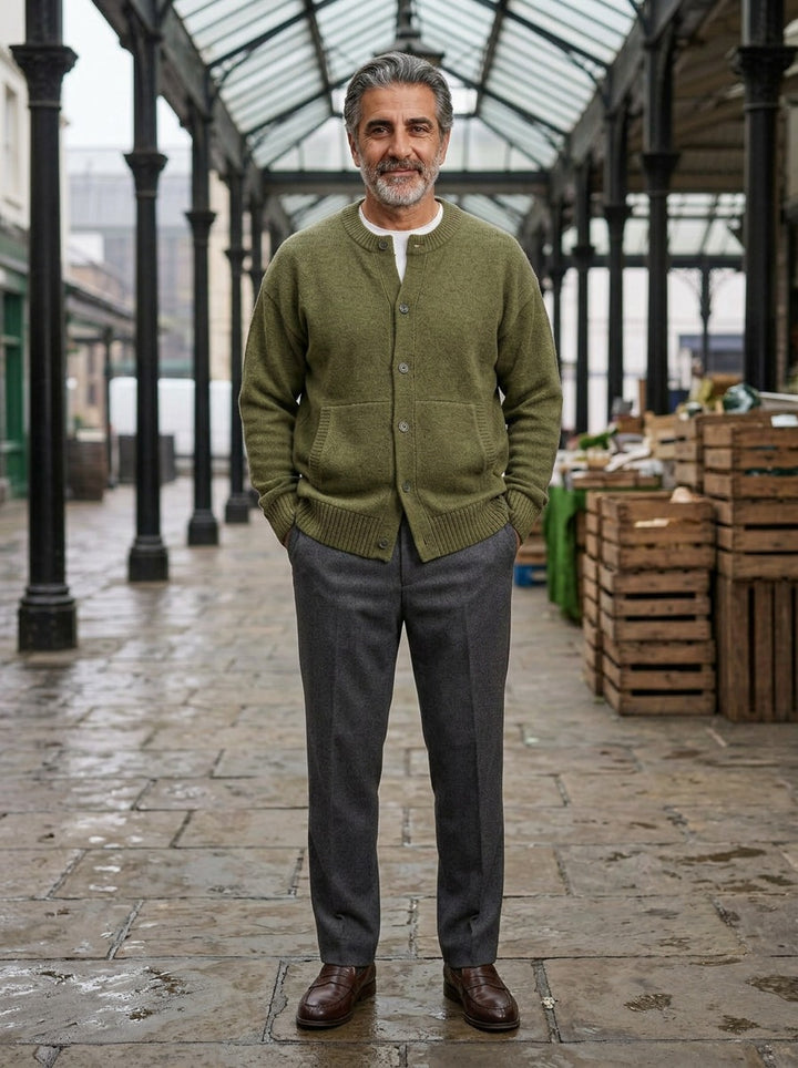Selby round neck cardigan in Olive, lifestyle in a covered market hall, Gentlemens Manor