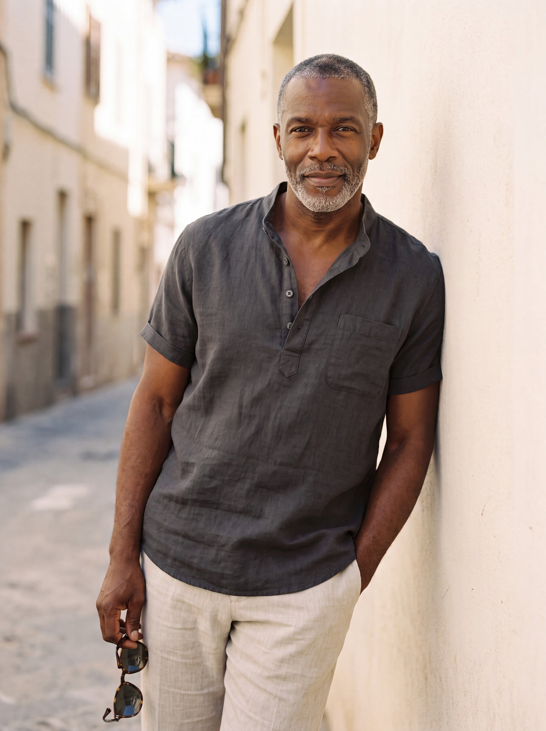 Sterling Men linen shirt in black, worn by a model on a Mediterranean terrace - Gentlemens Manor lifestyle