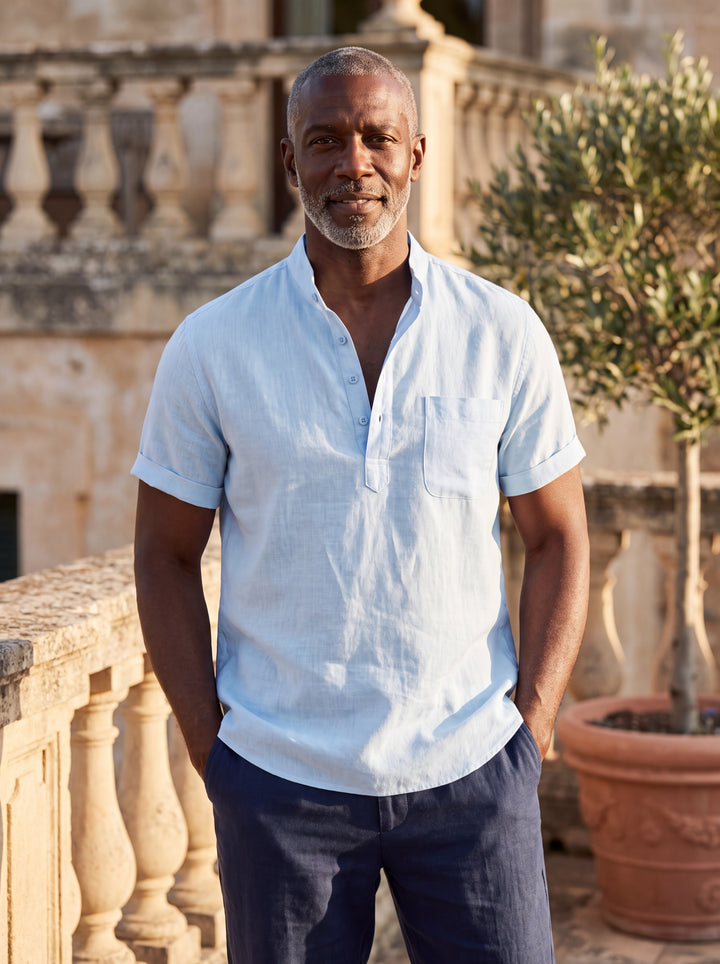 Sterling Men linen shirt in light blue, worn by a model on a Mediterranean terrace - Gentlemens Manor lifestyle