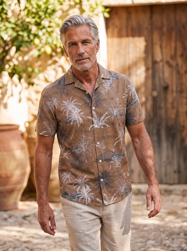 Sterling Men short sleeve shirt in brown, worn by a model on a Mediterranean terrace - Gentlemens Manor lifestyle