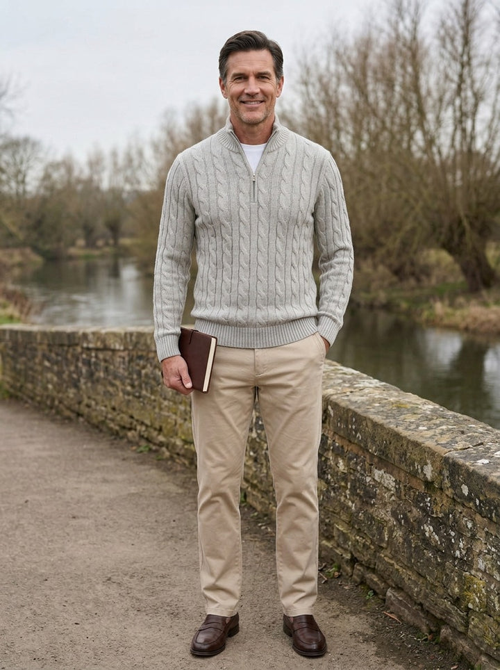 Sutherland cable knit quarter zip sweater in Light Grey, lifestyle on a stone footbridge, Gentlemens Manor