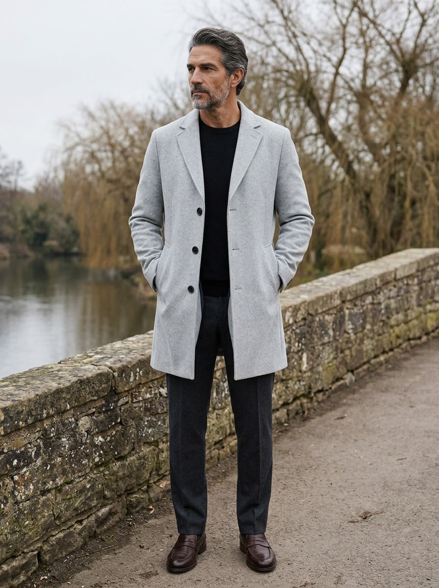 Thackeray overcoat in Light Grey, lifestyle on a stone footbridge, Gentlemens Manor