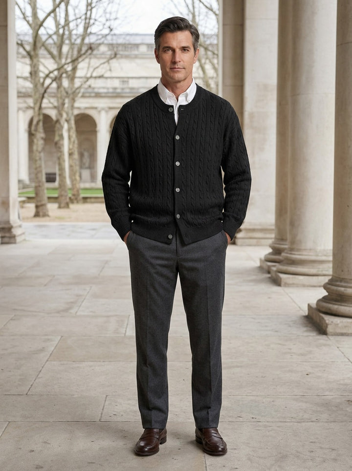 Tierney cable knit crew neck cardigan in Black, lifestyle in a stone colonnade, Gentlemens Manor
