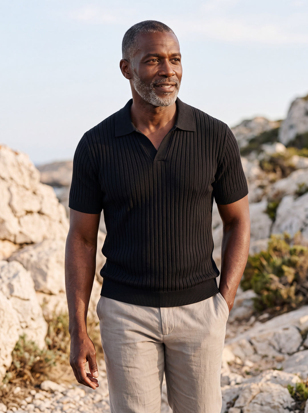 Vernon Men polo shirt in black, worn by a model on a Mediterranean terrace - Gentlemens Manor lifestyle