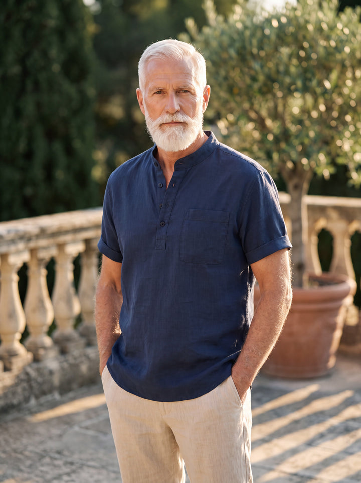 Vincent Men linen shirt in Navy, worn by a model on a Mediterranean terrace - Gentlemens Manor lifestyle