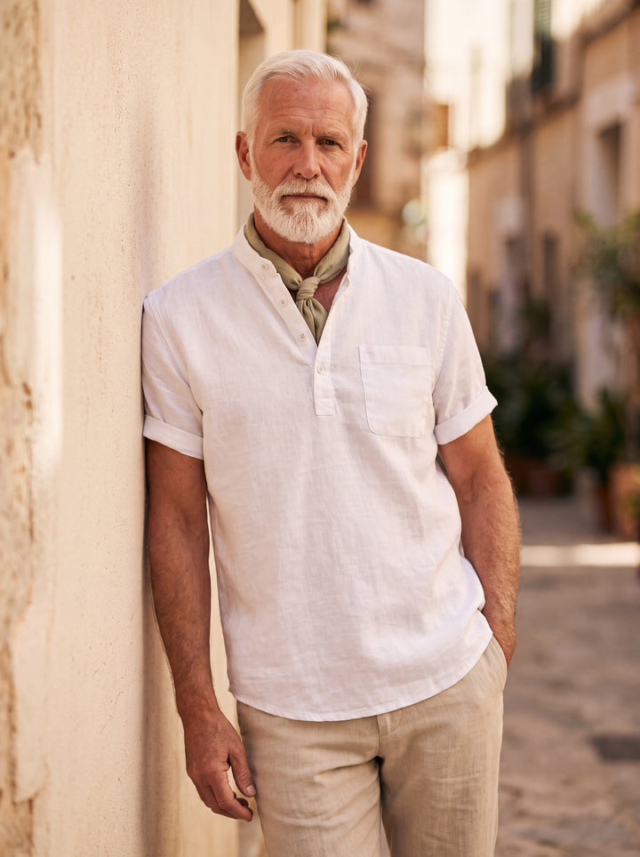 Vincent Men linen shirt in white, worn by a model on a Mediterranean terrace - Gentlemens Manor lifestyle