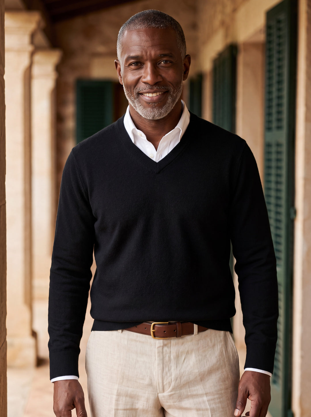Wallace sweater in Black, worn by a model in a Mediterranean setting - Gentlemens Manor lifestyle