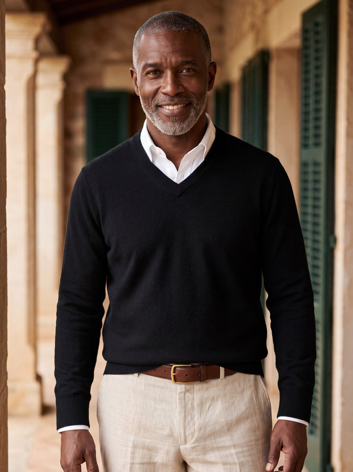 Wallace sweater in Black, worn by a model in a Mediterranean setting - Gentlemens Manor lifestyle