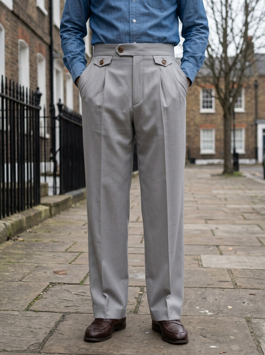 Whitley wide leg pleat tab trousers in Grey, lifestyle on a street of brick row houses, Gentlemens Manor