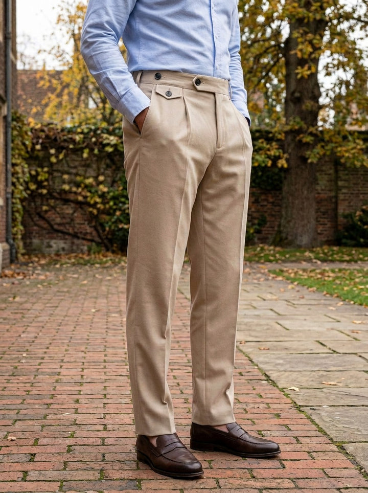 Wilfred button tab tapered trousers in Beige, lifestyle in a brick college courtyard, Gentlemens Manor