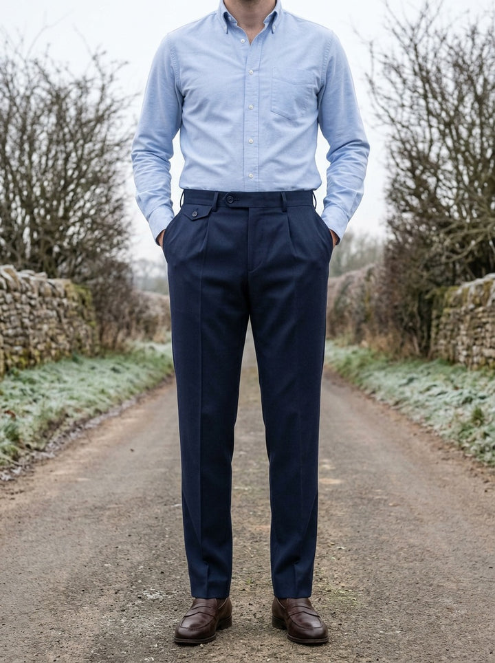 Wilfred button tab tapered trousers in Navy, lifestyle on a country lane, Gentlemens Manor