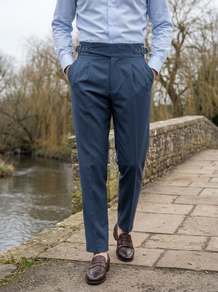 Wyatt crossover strap high waisted trousers in Blue, lifestyle on a stone footbridge, Gentlemens Manor